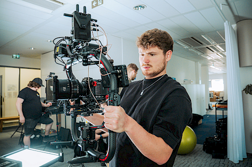 Cameraman preparing the camera for filming