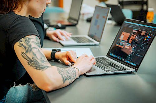 Team with open laptops in the meeting room