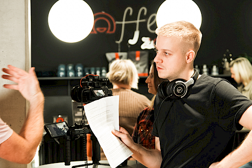 Cameraman filming testimonial with clients